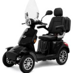 Zwarte vierwiel-scootmobiel met hoge rugleuning, armsteunen, ruit, spiegels en koplamp.