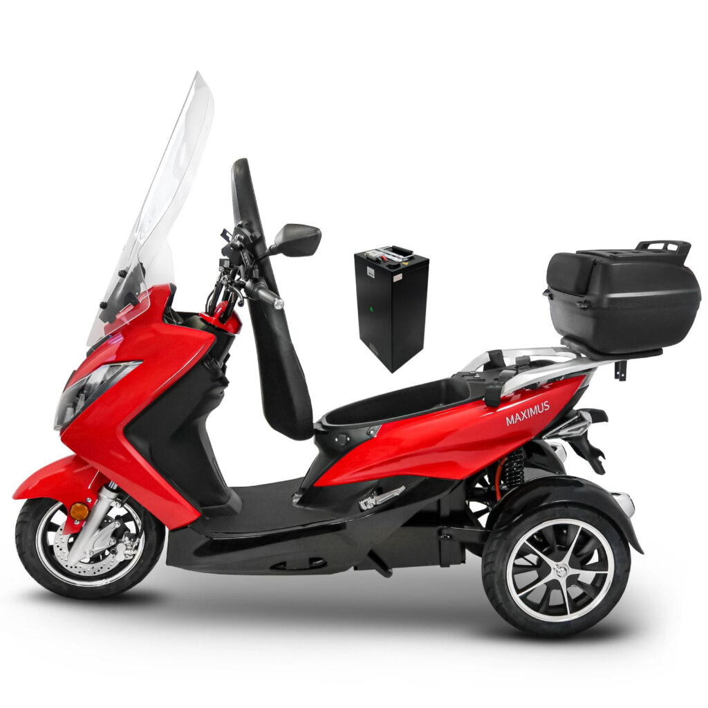 Rode driewielige elektrische scooter met ruit en topkoffer, losse accu ernaast.